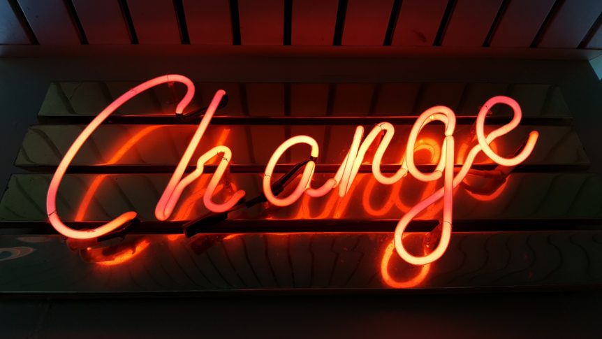 A neon sign that says change in red.